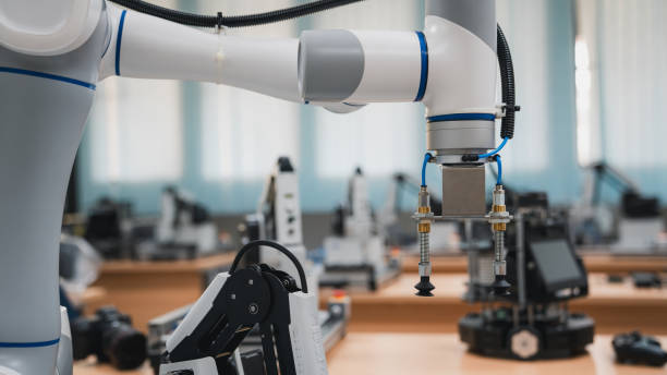 istock Automated robot arm for packing and moving metal components into cardboard boxes. fully automated warehouse. 1805424924