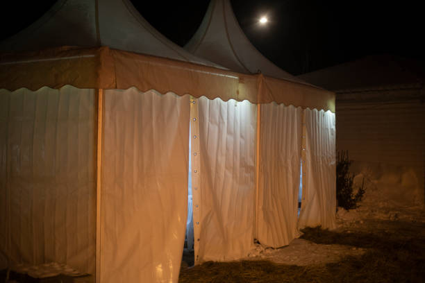 istock White changing tent on street. Tent for warming up after bathing. White awning. 1805428104