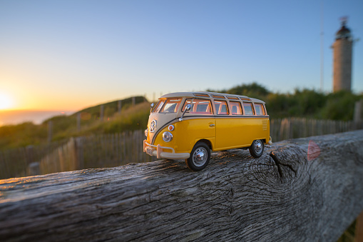 Cap de gris nez, France - July 7, 2022: A 9 seater minibus on a piece of wood near the sea, sunset, sea