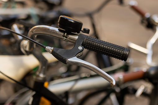 Close-up of a bicycle brake with selective focus on the street