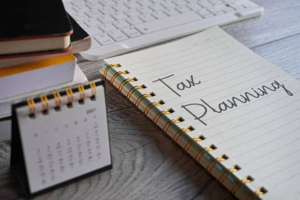 Closeup image of notebook with text TAX PLANNING and calendar.