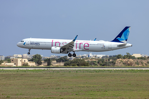 Luqa, Malta - October 1, 2023: Azores Airlines Airbus A321-253NX (REG: CS-TSI) coming in to land for maintenance at LTM.