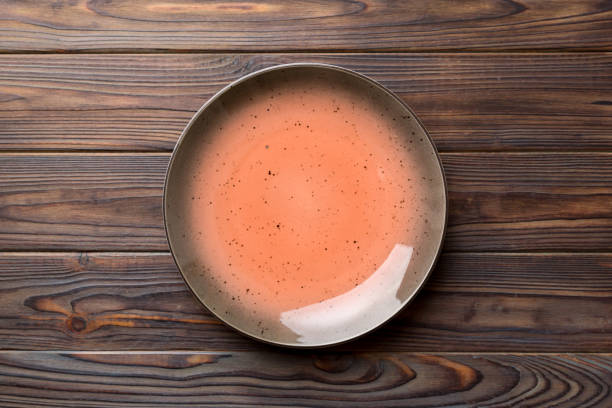 istock Top view of empty red plate on wooden background. Empty space for your design 1805438877