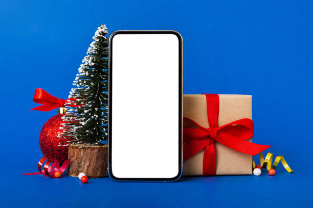 istock Digital phone mock up with rustic Christmas decorations for app presentation with empty space for you design. Christmas online shopping concept. Tablet with copy space on colored background 1805439496