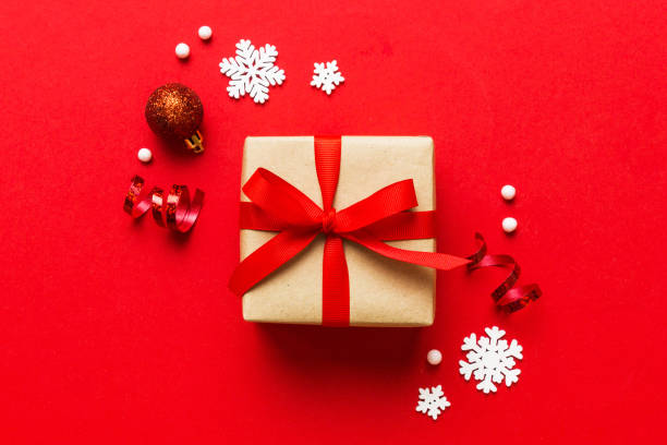 istock Top view Flat lay Christmas decorations and gift box on colored background with copy space. Christmas or Happy New Year composition 1805439509