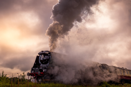 Steam train in motion with  carriages