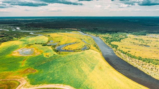istock Drone Aerial View Spring Meadow Field Pasture And Curved River Marsh. Springtime Landscape. Top View From High Attitude In Summer Season. Drone View, . Bird's Eye View. Ecological Concept Background 1805457157