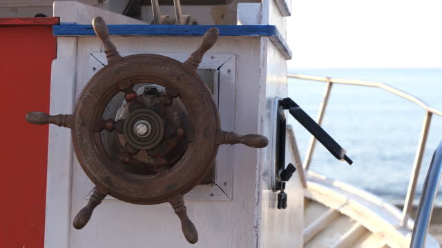 Helm steering wheel of a beached old boat