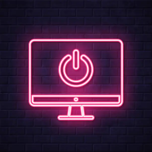 Vector illustration of Desktop computer with power button. Glowing neon icon on brick wall background