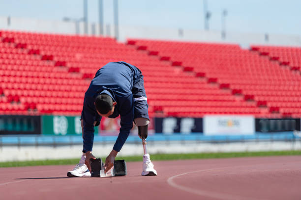 istock Disabled athletes prepare in starting position ready to run on stadium track 1805481437