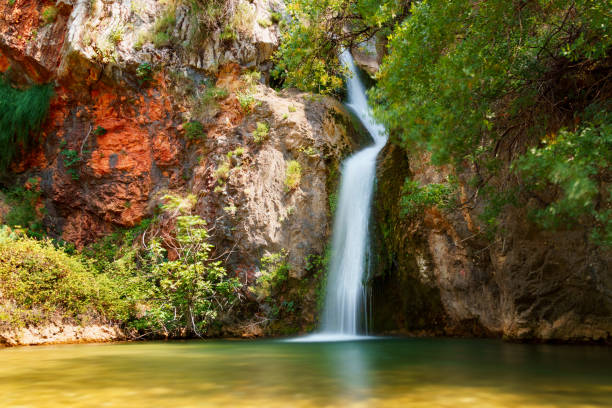 istock waterfall in the mountains, beautiful summer bright landscape 1805491299