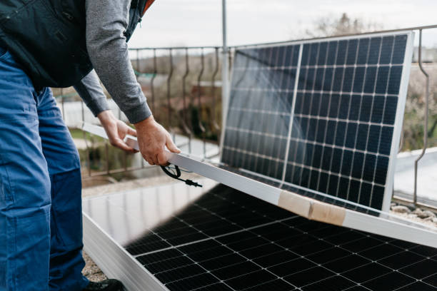 istock Close up of man holding solar panel. Eco concept alternative energy 1805491839
