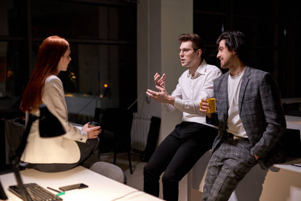 istock Side view on friendly office workers, colleagues having talk after hard working day 1805494038