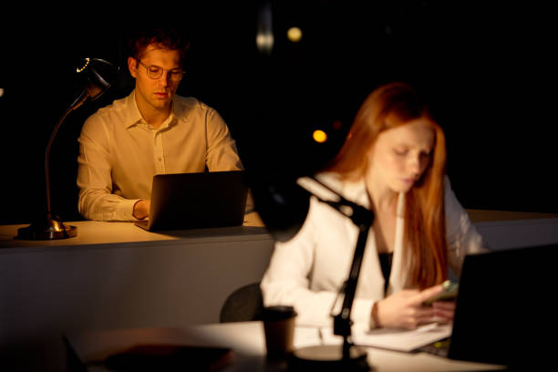 istock Serious concentrated Capable Manager Working Late Hours in Office. Office is Dark 1805494039