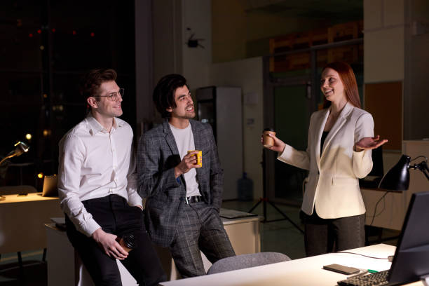 istock Side view on friendly office workers, colleagues having talk after hard working day 1805494055