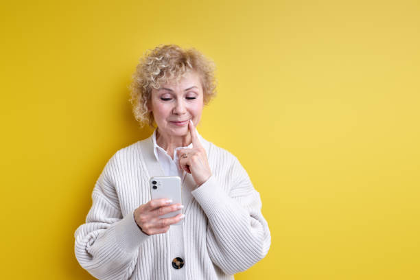 istock Elderly Woman Thinking While Chatting With Someone On Phone 1805496777