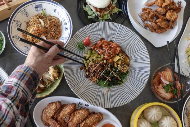 istock Hand holding chopsticks for eating at restaurant table . 1805498400