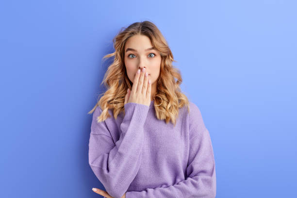 istock Surprised Female Close Mouth In Shock, Isolated On Blue Background 1805500041