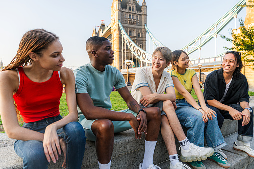 Multiracial group of happy young friends bonding in London city - Multiethnic teens students meeting and having fun in Tower Bridge area, UK - Concepts about youth lifestyle, travel and tourism