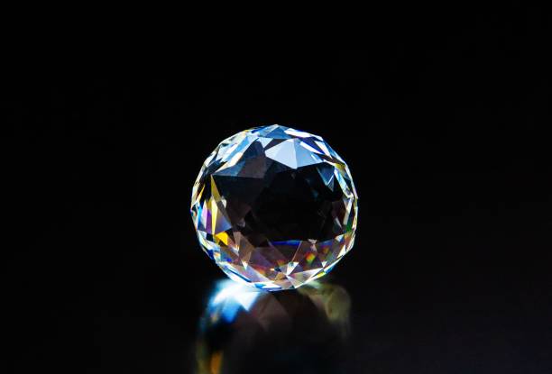 istock Bright gemstone on a dark background, radiating sparkles of light and color 1805516500