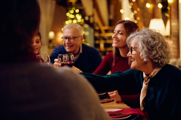 istock Happy extended family toasting during Christmas dinner at dining table. 1805517650