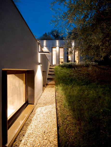 istock Contemporary house surrounded by olive trees, built on terraced land. Front view in night scene 1805521713