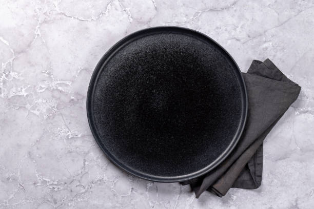 istock Mockup for a delicious meal. Empty plate on a table 1805521800