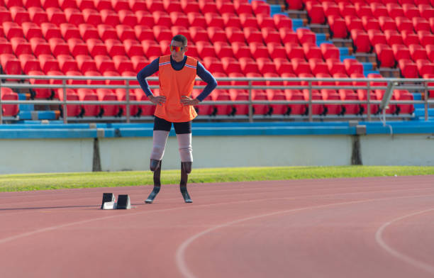 istock Disabled athletes prepare in starting position ready to run on stadium track 1805522236