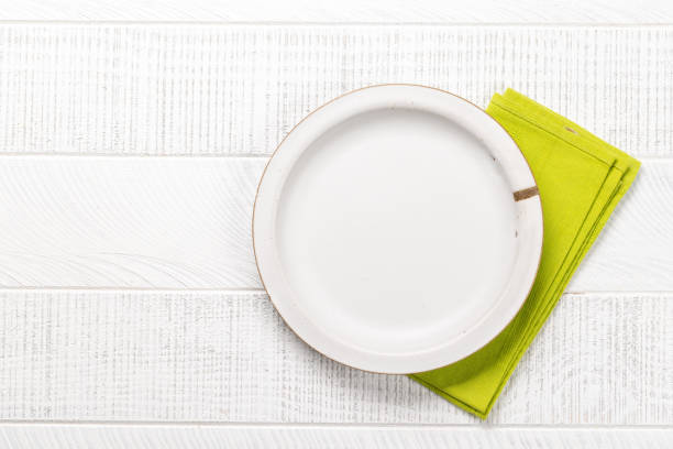 istock Mockup for a delicious meal. Empty plate on a table 1805522987
