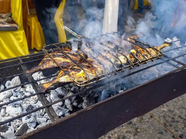 Grilling fish in open air restaurant.