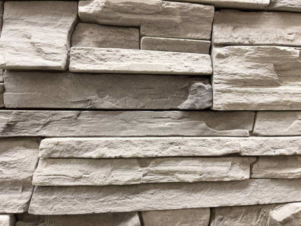 istock Background of stone wall texture. Modern style design decorative uneven cracked surface. 1805538863