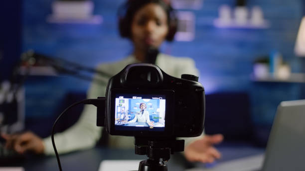 istock African influencer recording blog looking at professional camera 1805552410