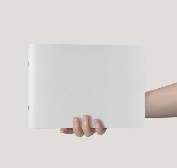 istock Hand Holding Horizontal A4 Brochure Mockup on a White Background 1805554549