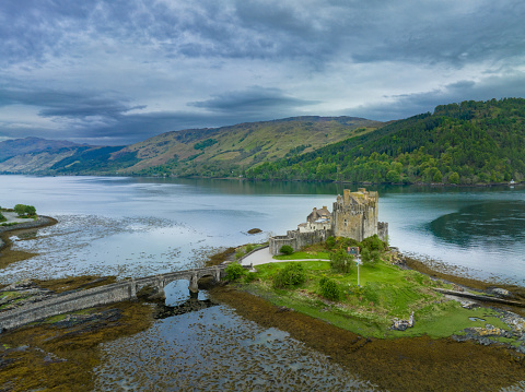 Eilean Donan Castle is one of the most recognised castles in Scotland, and probably appears on more shortbread tins and calendars than any other. It is, without doubt, a Scottish icon and certainly one of the most popular visitor attractions in the Highlands. When you first set eyes on it, it is easy to understand why so many people flock to its stout doors year after year. Strategically located on its own little island, overlooking the Isle of Skye, at the point where three great sea-lochs meet, and surrounded by the majestic splendour of the forested mountains of Kintail, Eilean Donan’s setting is truly breath-taking.
