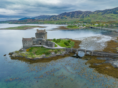 Eilean Donan Castle is one of the most recognised castles in Scotland, and probably appears on more shortbread tins and calendars than any other. It is, without doubt, a Scottish icon and certainly one of the most popular visitor attractions in the Highlands. When you first set eyes on it, it is easy to understand why so many people flock to its stout doors year after year. Strategically located on its own little island, overlooking the Isle of Skye, at the point where three great sea-lochs meet, and surrounded by the majestic splendour of the forested mountains of Kintail, Eilean Donan’s setting is truly breath-taking.