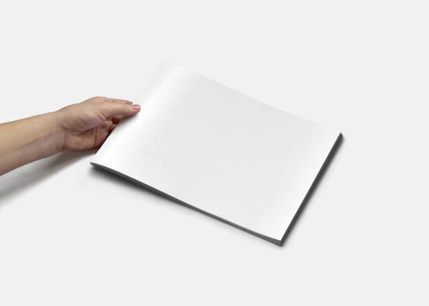 istock Hand Holding Horizontal A4 Brochure Mockup on a White Background 1805554756