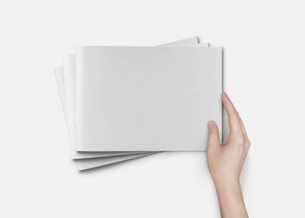 istock Hand Holding Horizontal A4 Brochure Mockup on a White Background 1805556063