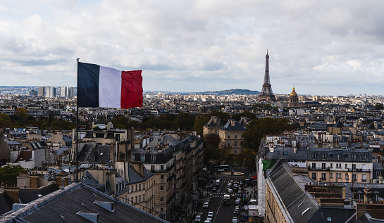 Paris skyline panorama with the Eiffel Tower and French flag