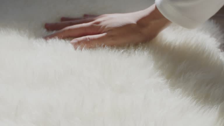 Close up of hand touching soft carpet, fluffy soft and comfortable.