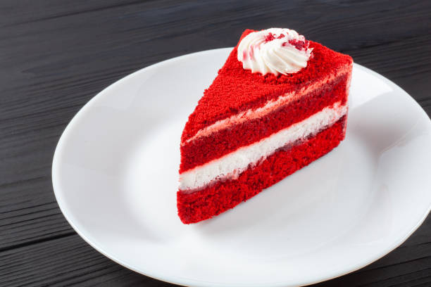 istock Single Slice Red Velvet Cake On White Plate on dark wooden table. 1805582127