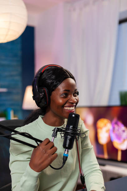 istock Cheerful creative vlogger recording podcast using production station in home studio. 1805585849