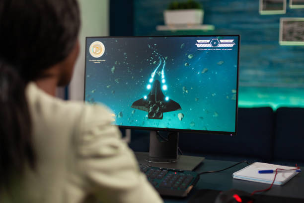 istock Successful gamer woman holding controller playing space shooter video games 1805598339