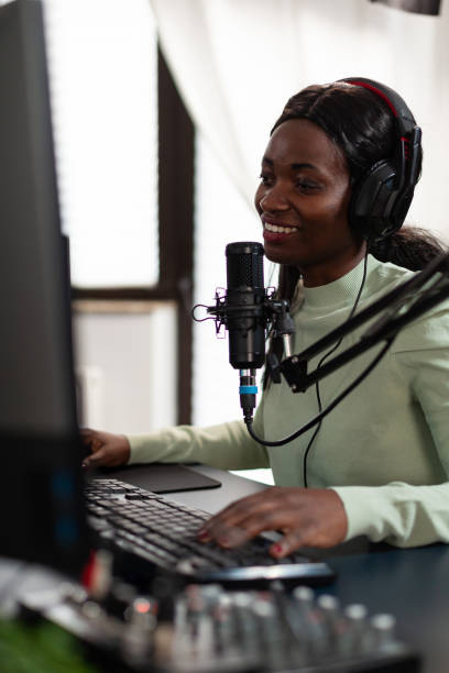 istock Competitive african american gamer smiling while talking with players 1805604510