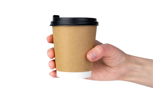 istock Woman's hand holds a craft disposable paper cup with fresh coffee isolated on a white background. Close-up. 1805608875