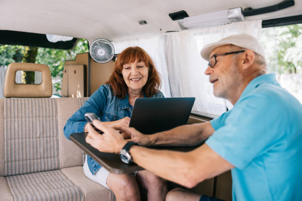 istock Senior couple working on the go from their campervan. 1805620164