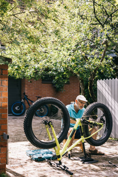 istock Senior man doing maintenance on his fatbike 1805620219