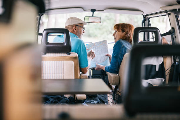 istock Senior couple looking at map together in campervan 1805620734