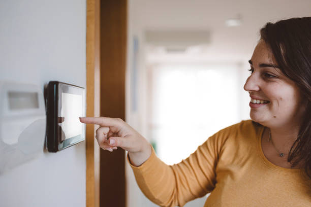 istock A woman uses an intercom to open the door 1805624541