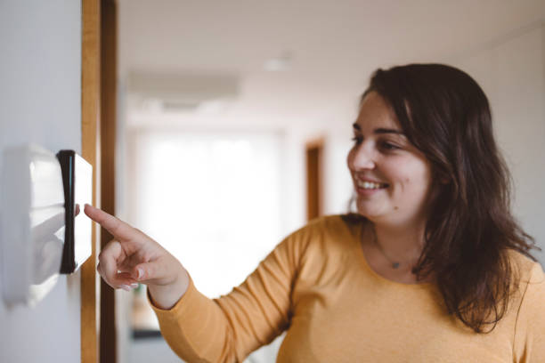 istock A woman uses an intercom to open the door 1805625066