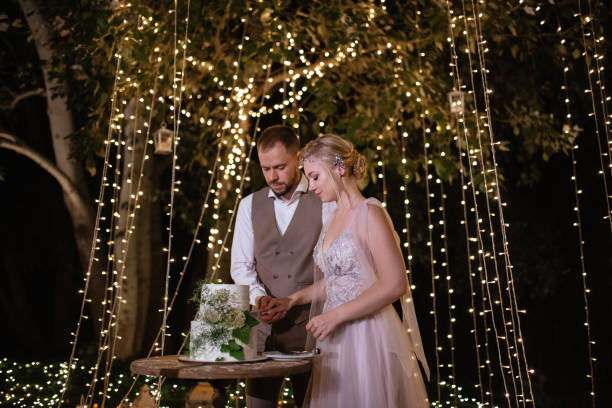 istock newlyweds happily cut and taste the wedding cake 1805625652